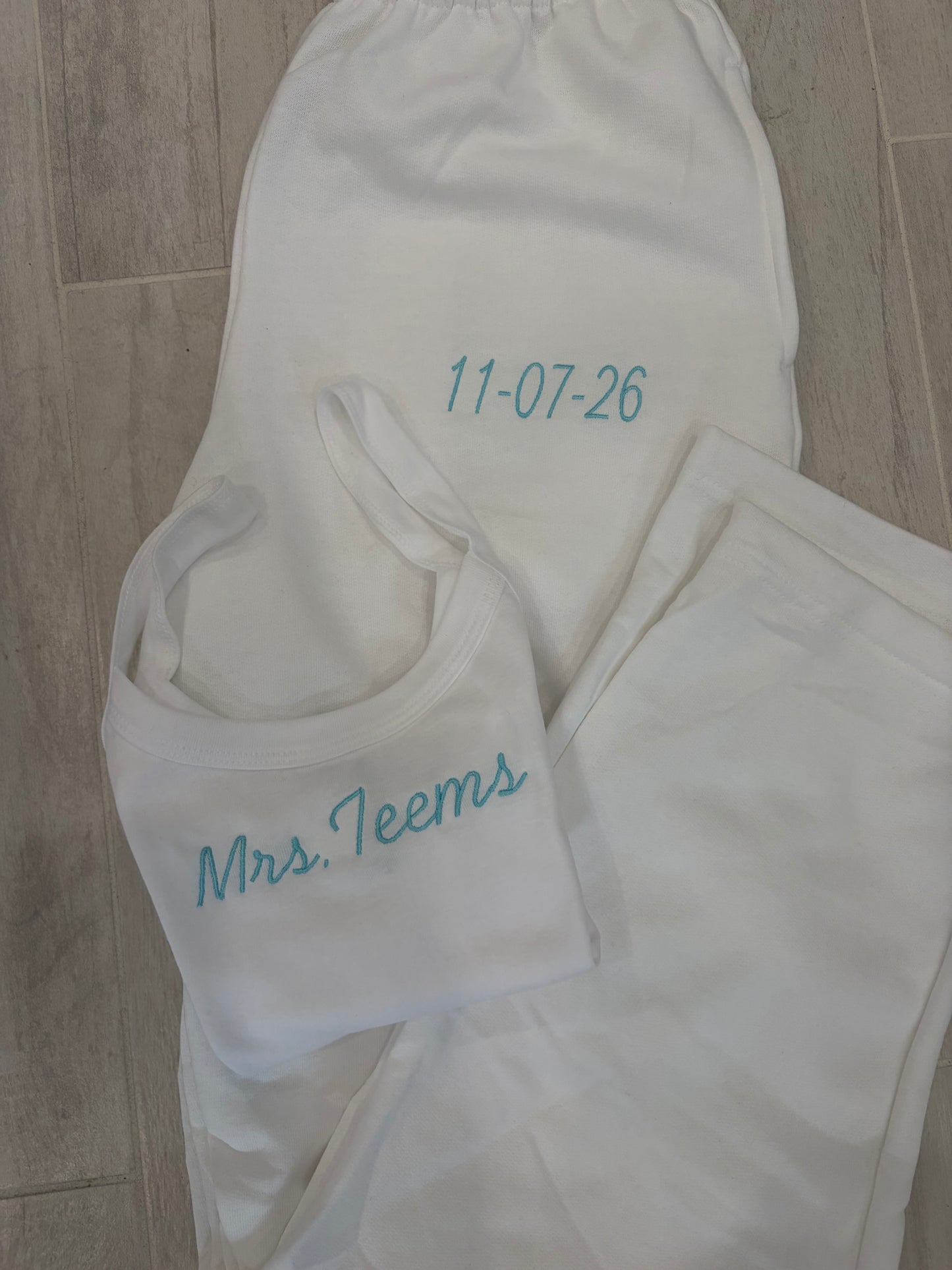 Custom embroidered tank top and open bottom sweatpants