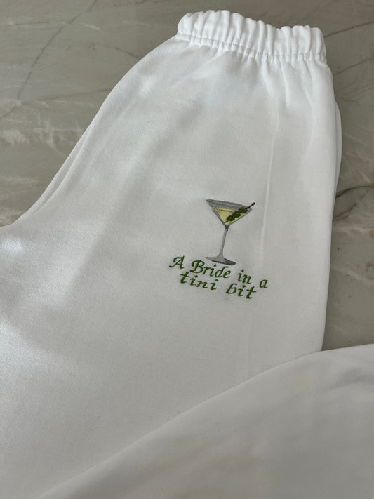 A bride in a tini bit embroidered sweatpants