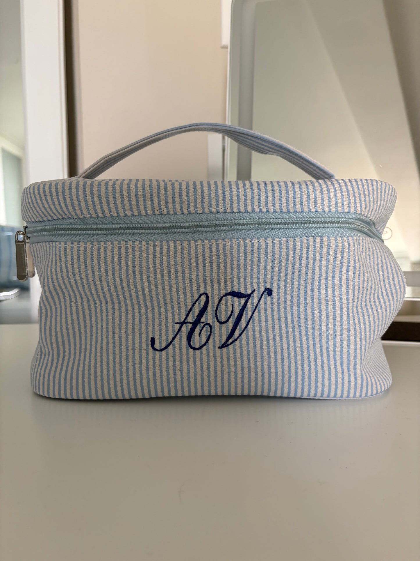 Striped embroidered makeup bag