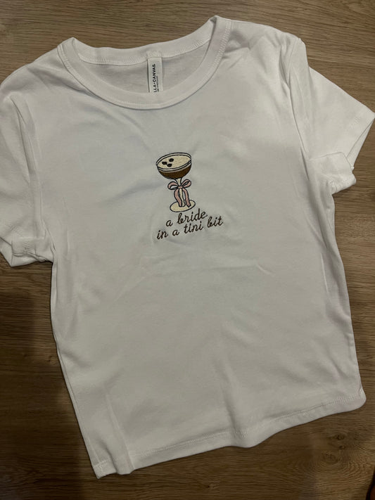 A bride in a tini bit espresso bow baby doll tee