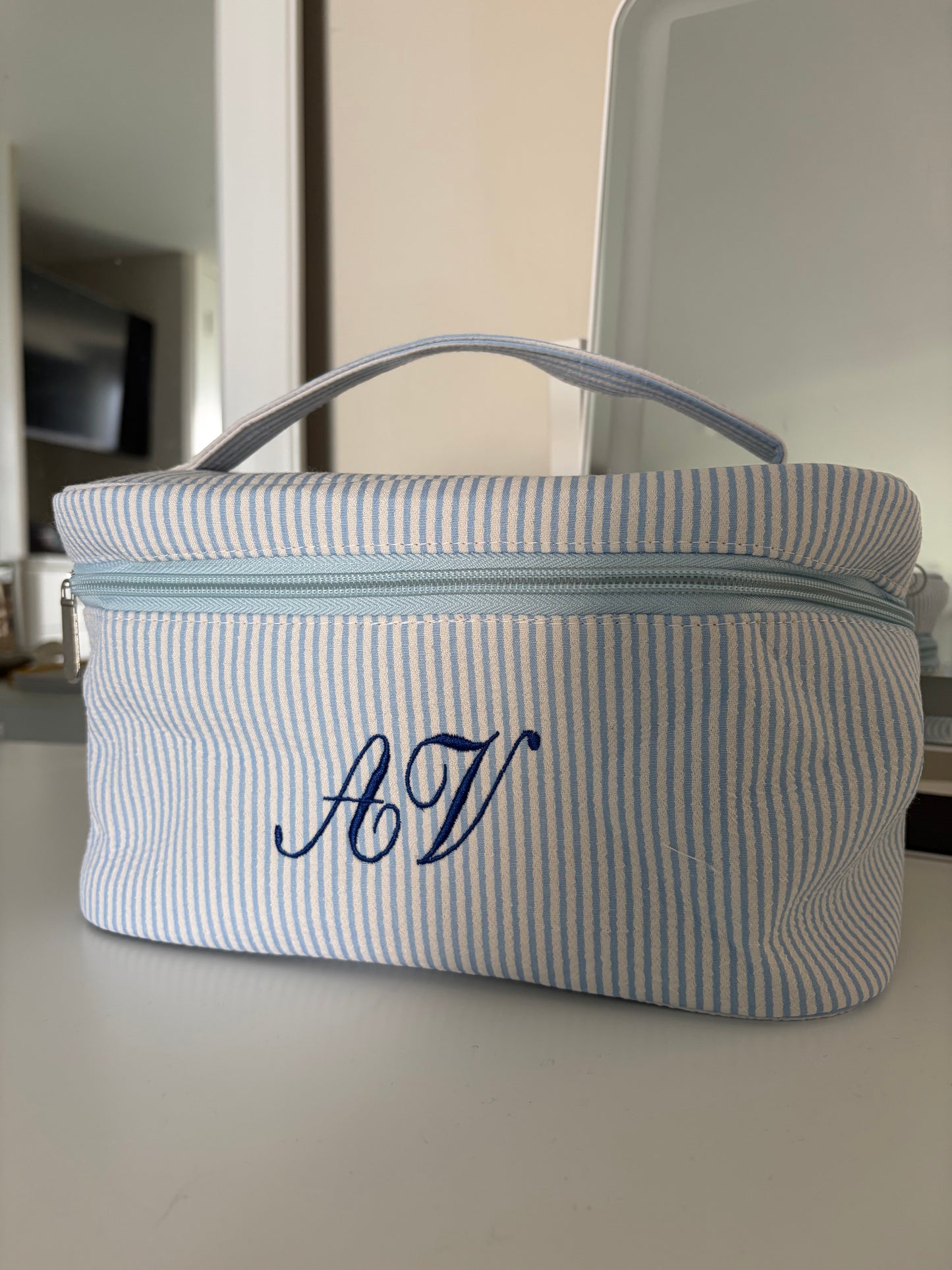 Striped embroidered makeup bag