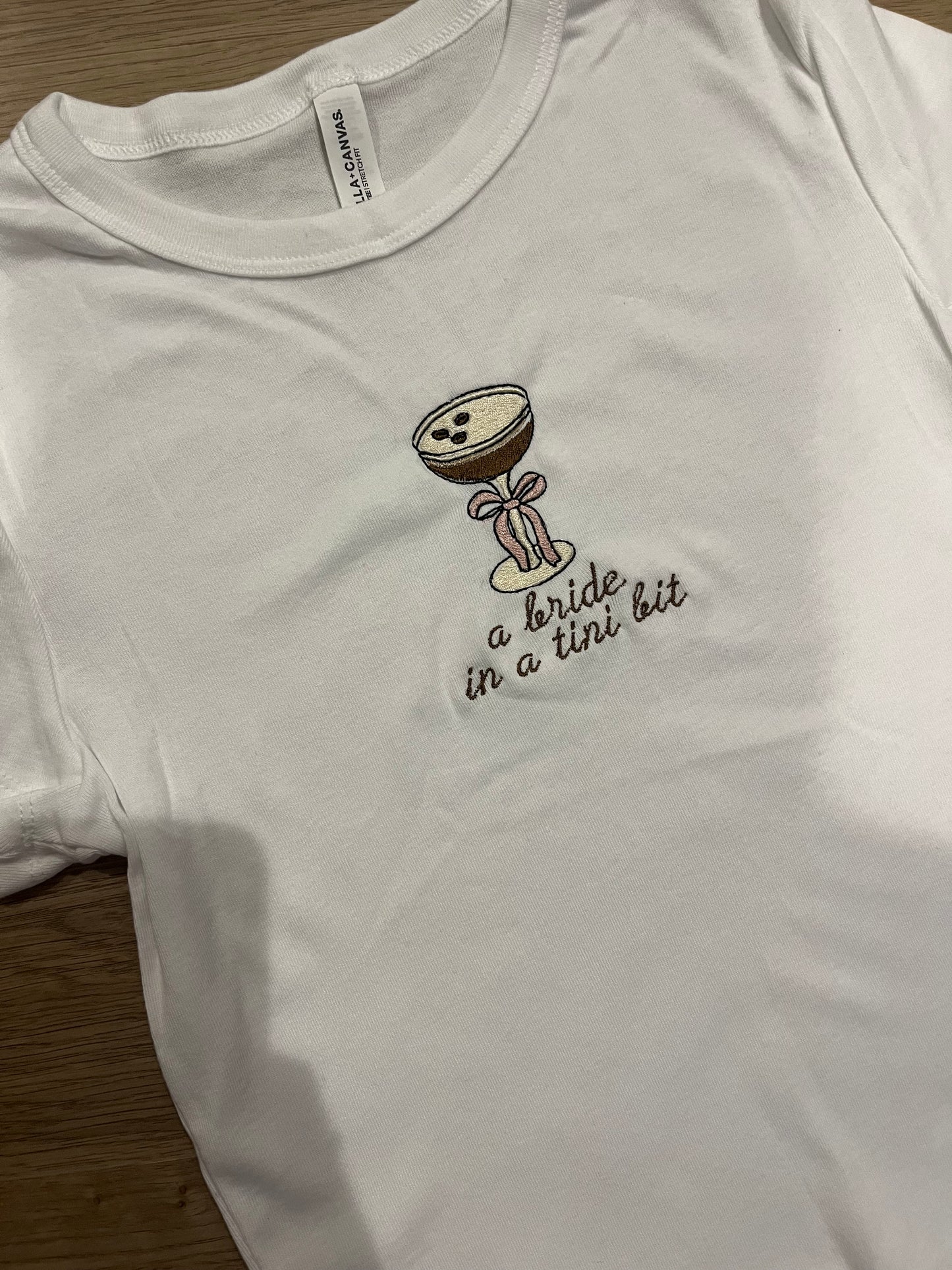 A bride in a tini bit espresso bow baby doll tee