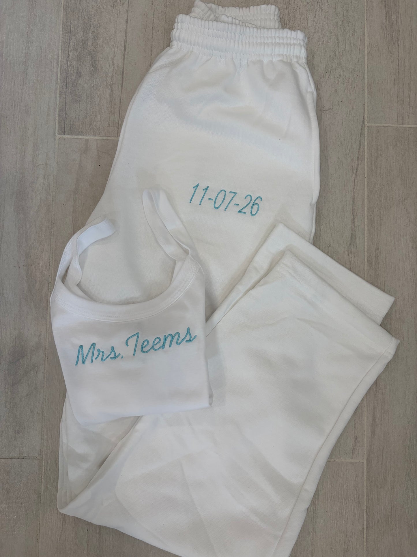 Custom embroidered tank top and open bottom sweatpants